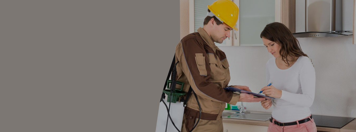 Brantford Pest Control technician reviewing a treatment plan with a homeowner in her kitchen